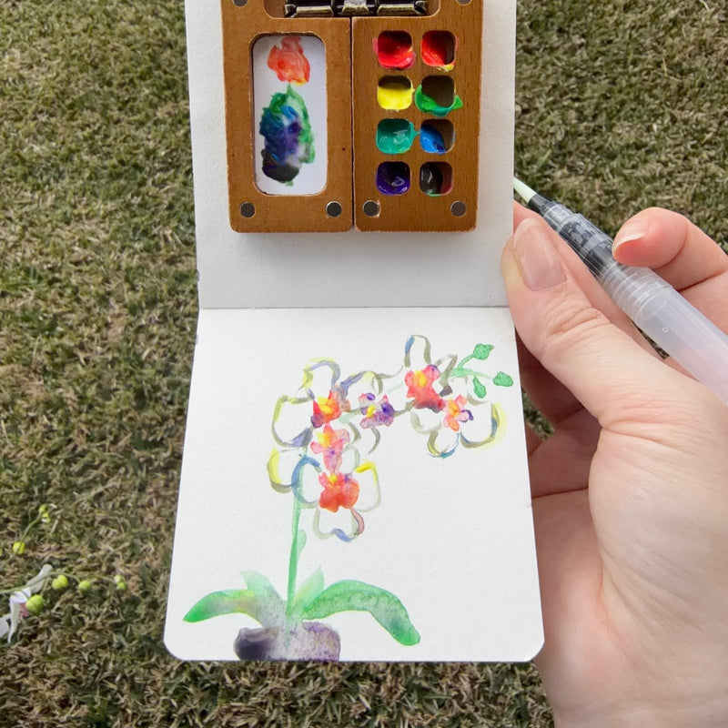 Pocket Artist art kit with watercolor supplies and finished painting